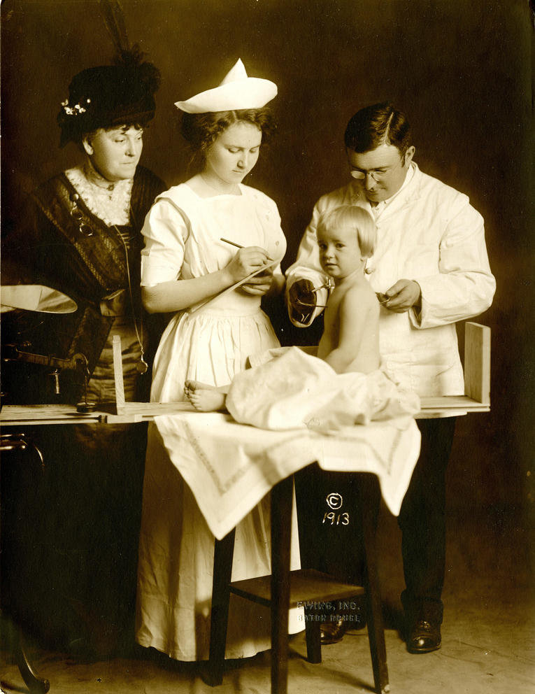 A baby is evaluated for "desirable traits" in 1879.