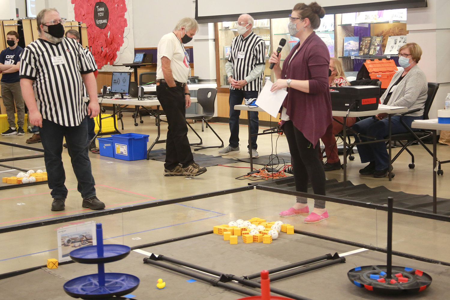 Jenny Kassil, shown holding a microphone, head coach of the Robotics team for North Thurston High School, speaks at the Nov. 13, 2021 competition.