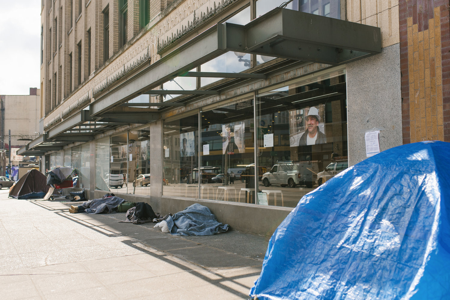 The tents of homeless people in downtown Seattle are shown directly outside a retailer's windows.