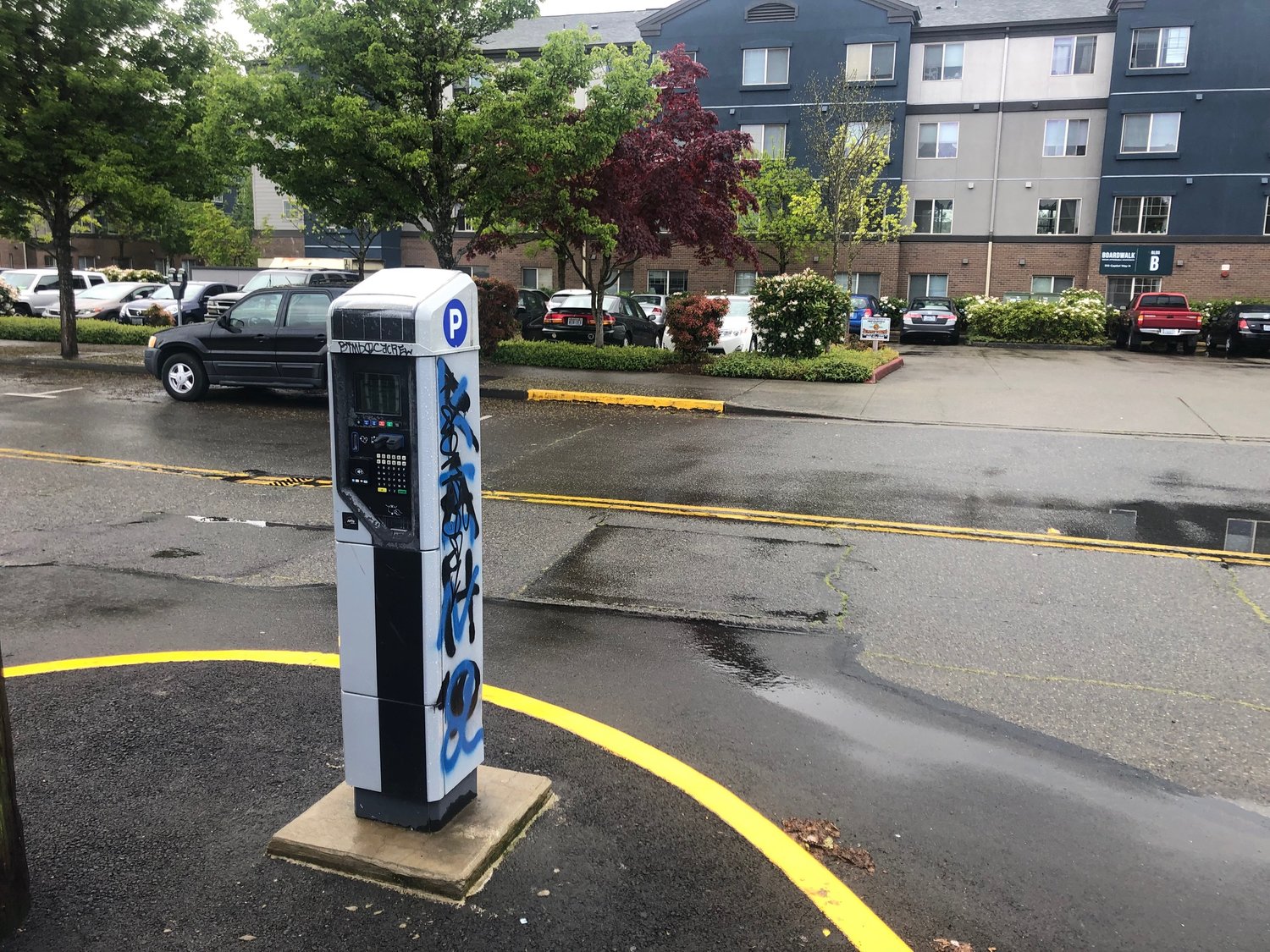 An electric car charging kiosk at Washington Street between A and B Avenues.