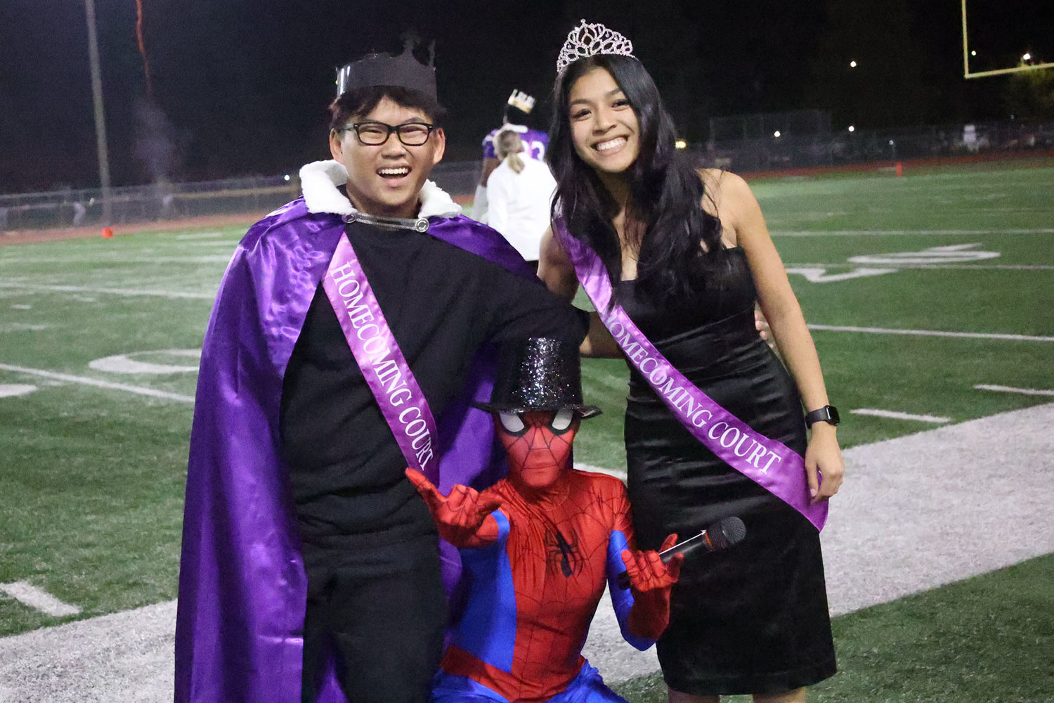 Homecoming King Anthony Lin and Queen Camille Marquez with a fictional arachnid.