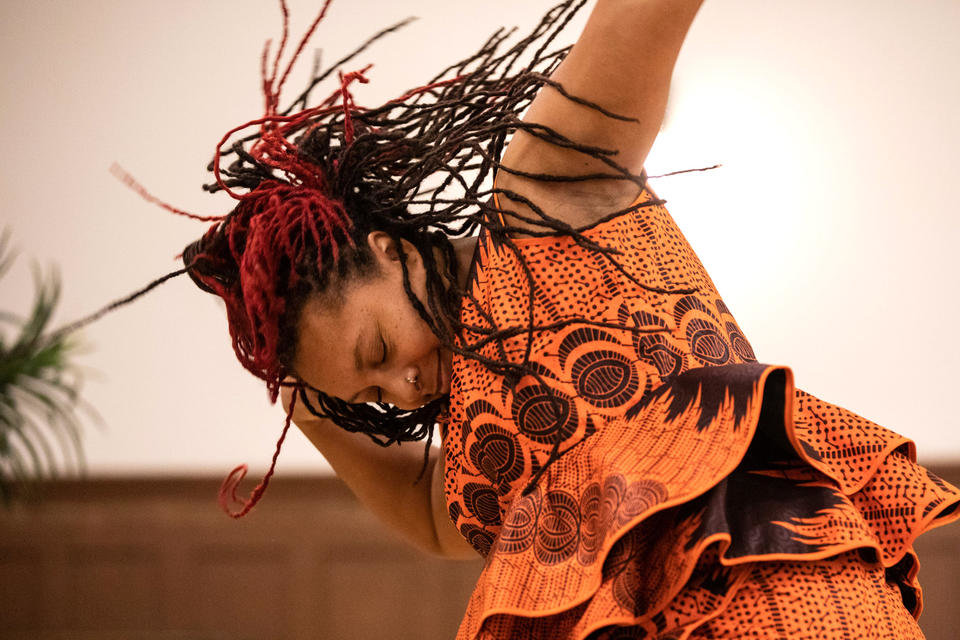 Nailah Bulley of ADEFUA Cultural Education Workshop, who teaches African drumming and dancing, performs at Northwest African American Museum’s Kwanzaa celebration at Washington Hall on Thursday, Dec. 29, 2022. (Amanda Snyder/Crosscut)