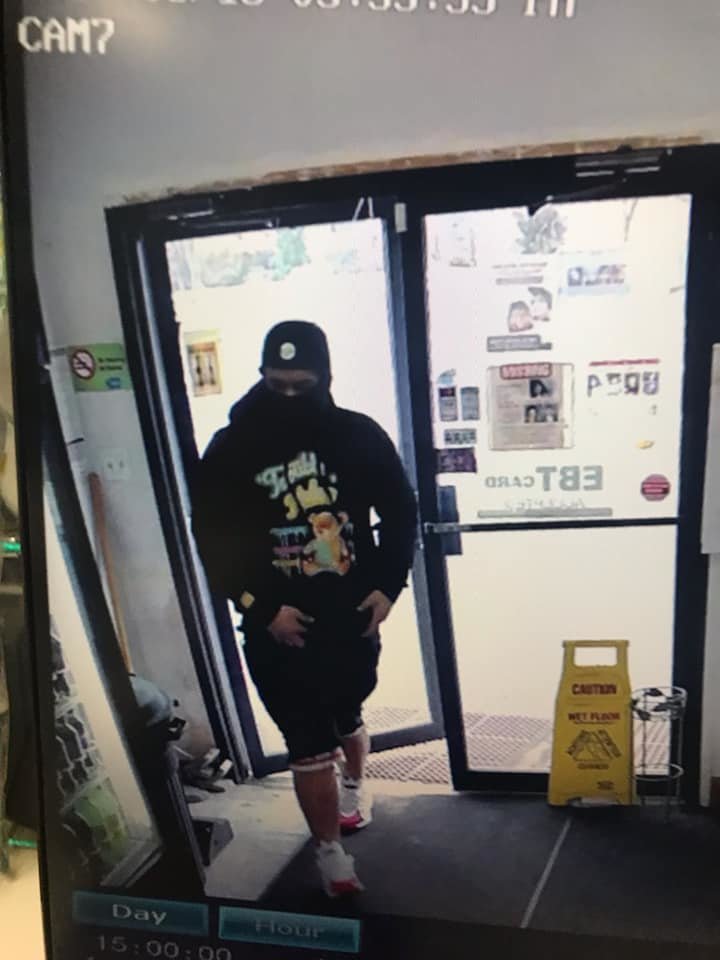 Surveillance photo of the suspect entering the store.