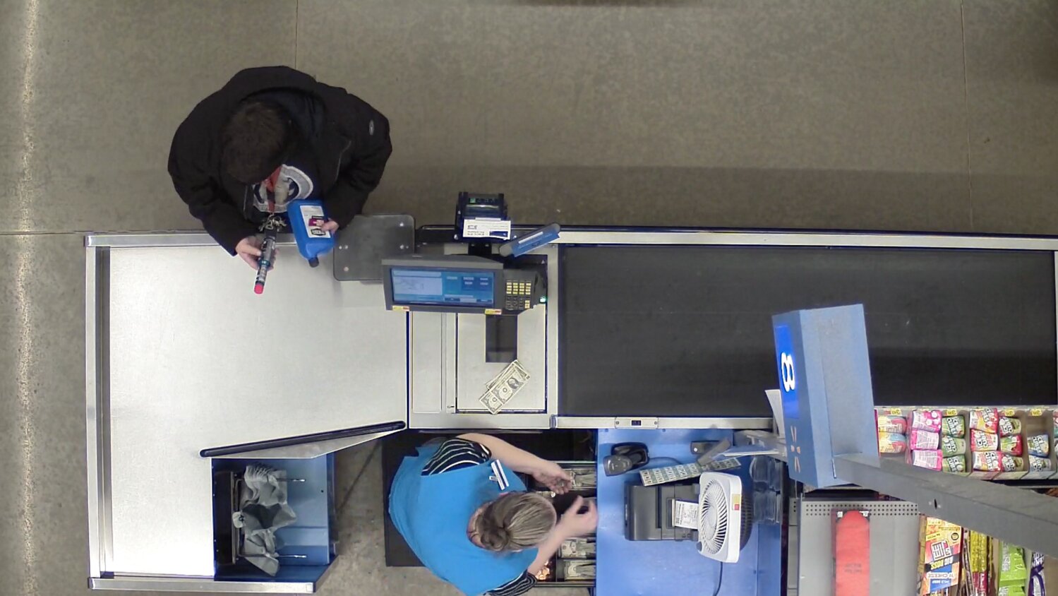 Bourke is seen setting a portion of the customer’s payment aside instead of placing the full amount in the cash register. (Photo is from a frame of the Tumwater Police Department video)