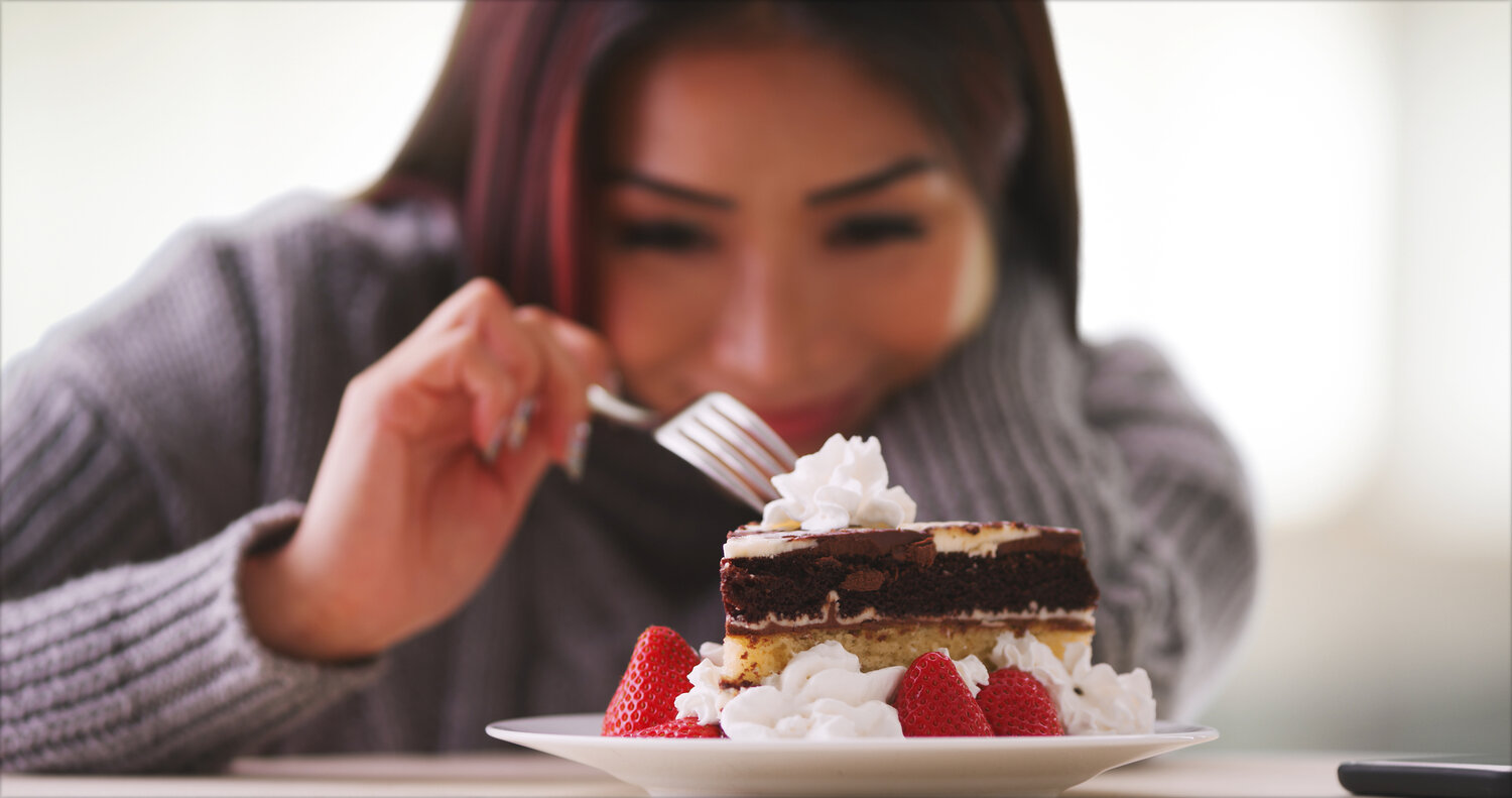 A woman indulging in a dessert